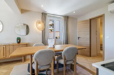 a dining room with a wooden table and chairs at 62 CARNOT LOT 7 - Appartement Duplex Atypique- climatise - 2 chambres in Nice