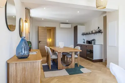a kitchen and dining room with a table and chairs at 62 CARNOT LOT 7 - Appartement Duplex Atypique- climatise - 2 chambres in Nice