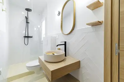 a bathroom with a sink and a toilet and a mirror at 62 CARNOT LOT 7 - Appartement Duplex Atypique- climatise - 2 chambres in Nice