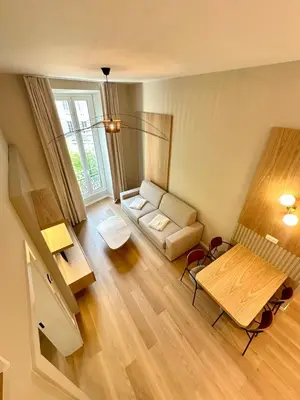 a living room with a couch and a table at Appartement neuf d architecte Carré d Or in Nice