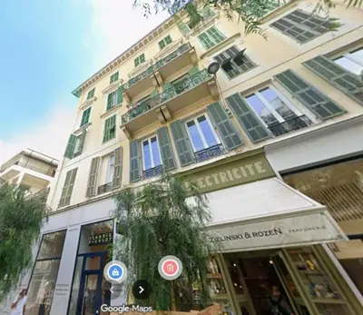 a large building on a street in front of a store at Appartement neuf d architecte Carré d Or in Nice