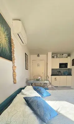 a bedroom with a bed with blue pillows on it at T2 Cozy & Air-conditioned, close to All Amenities in Nice