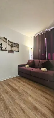 a living room with a couch and a wooden floor at T2 Cozy & Air-conditioned, close to All Amenities in Nice