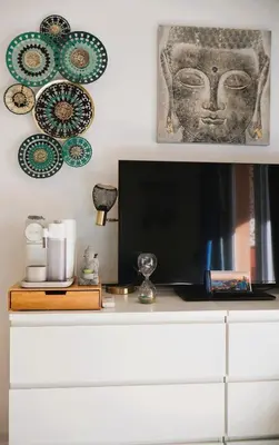 a white dresser with a tv and plates on a wall at T2 Cozy & Air-conditioned, close to All Amenities in Nice