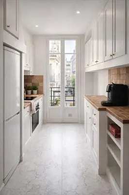 a kitchen with white cabinets and a large window at Blanche - From Nice with love in Nice