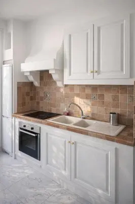 a kitchen with white cabinets and a sink at Blanche - From Nice with love in Nice
