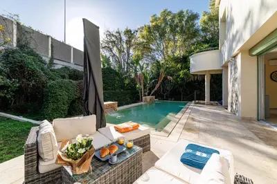 a backyard with a swimming pool and a house at VILLA MARIE -Pool - Garden-Close To Beach -Parking in Nice