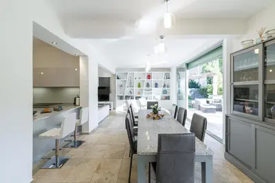 a kitchen and dining room with a table and chairs at VILLA MARIE -Pool - Garden-Close To Beach -Parking in Nice