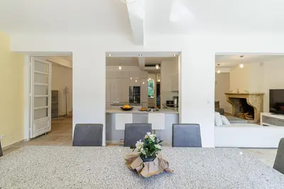 a dining room and kitchen with a table and chairs at VILLA MARIE -Pool - Garden-Close To Beach -Parking in Nice