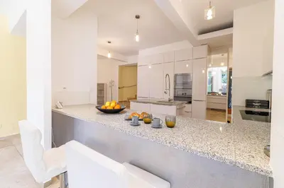 a kitchen with a counter with a bowl of fruit on it at VILLA MARIE -Pool - Garden-Close To Beach -Parking in Nice
