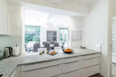 a kitchen with a counter with a bowl of fruit on it at VILLA MARIE -Pool - Garden-Close To Beach -Parking in Nice