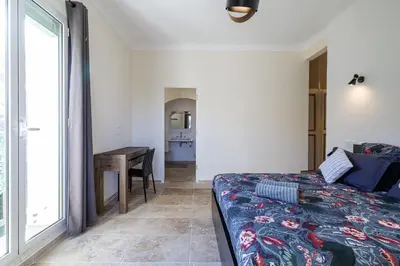 a bedroom with a bed and a desk and a window at VILLA MARIE -Pool - Garden-Close To Beach -Parking in Nice