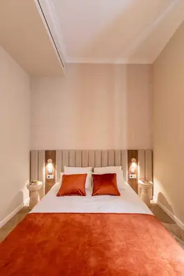 a bedroom with a large bed with two red pillows at 2BDR 6P central A C apt - heart of Nice in Nice