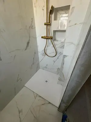 a bathroom with a shower with white marble at Appartement T3 NICE Promenade des Anglais in Nice