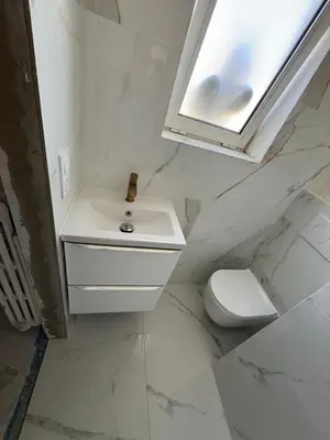 a white bathroom with a sink and a toilet at Appartement T3 NICE Promenade des Anglais in Nice