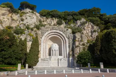 a building in front of a rocky mountain at Appartement Promenade Des Anglais - Happy Rentals in Nice