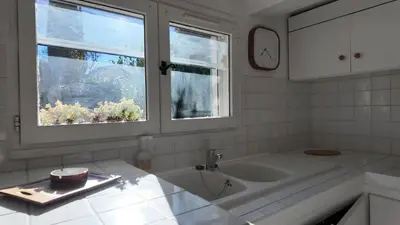 a white bathroom with a sink and two windows at Studio climatisé cosy dans une villa avec parking in Cagnes-sur-Mer