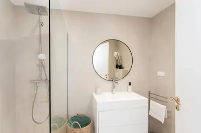 a bathroom with a sink and a mirror at Satywizus #22- Duplex panoramic sea view 2Bdr, AC, swimpool, parking, petanque in Nice