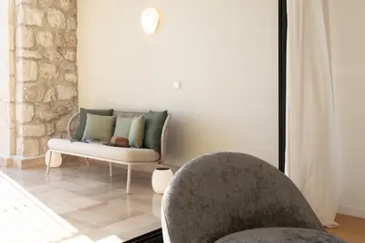 a living room with a chair and a couch at Satywizus #22- Duplex panoramic sea view 2Bdr, AC, swimpool, parking, petanque in Nice