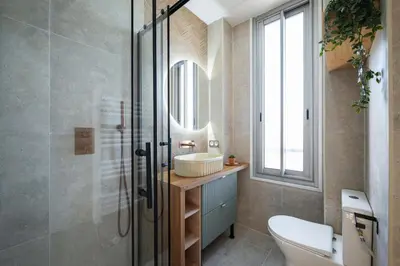 a bathroom with a sink and a glass shower at Vue mer panoramique - Cocon cosy et luxe - Clim et Wifi in Cagnes-sur-Mer