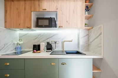 a kitchen with a sink and a microwave at Vue mer panoramique - Cocon cosy et luxe - Clim et Wifi in Cagnes-sur-Mer
