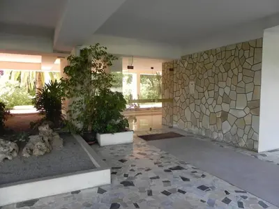 a room with a stone wall and some plants at 4 chambres, vue mer, calme in Nice