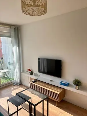 a living room with a flat screen tv on a wall at Charmant studio climatisé à Riquier, proche mer & gare in Nice