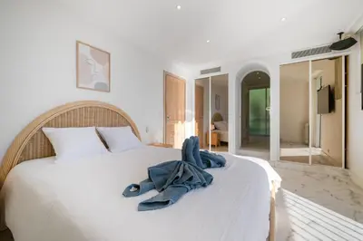 a bedroom with a bed with a blue robe on it at Vue exceptionnelle in Nice