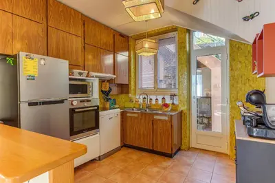 a kitchen with a refrigerator and a sink at VILLA BELLA VISTA BAY VI4488 By Riviera Holiday Homes in Villefranche-sur-Mer