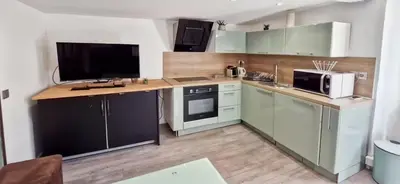 a kitchen with a counter with a microwave and a refrigerator at Sunny Old Town Studio in Nice
