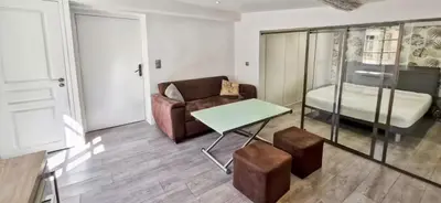 a living room with a couch and a table at Sunny Old Town Studio in Nice