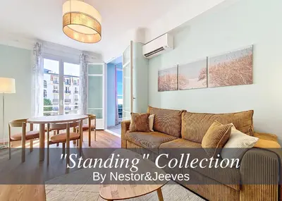 a living room with a couch and a table at Nestor&Jeeves - BLUE PASTEL PROMENADE - Spacious - Close sea in Nice