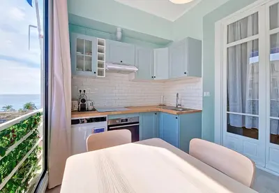 a kitchen with blue cabinets and a large window at Nestor&Jeeves - BLUE PASTEL PROMENADE - Spacious - Close sea in Nice