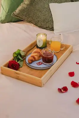 a tray with a plate of food and two glasses of orange juice at Superbe T3 tout confort à deux pas du tram et des plages in Nice