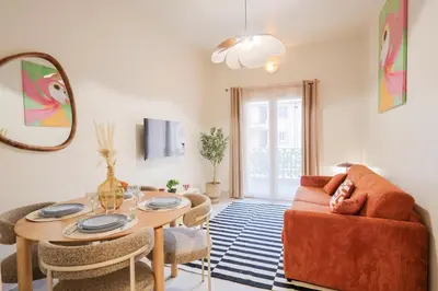 a living room with a table and a couch at Superbe T3 tout confort à deux pas du tram et des plages in Nice