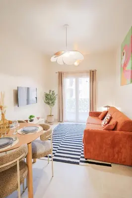 a living room with a couch and a table at Superbe T3 tout confort à deux pas du tram et des plages in Nice