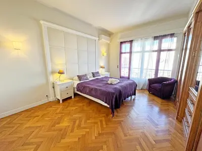 a bedroom with a bed and a chair in it at Panoramic Sea front Cote d Azur in Nice
