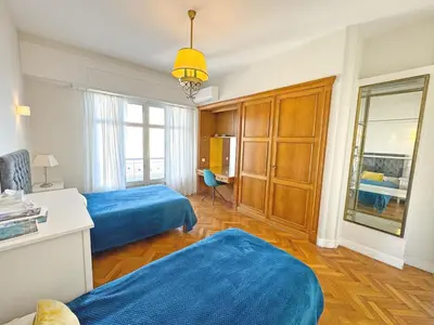 a bedroom with two beds and a desk and a window at Panoramic Sea front Cote d Azur in Nice
