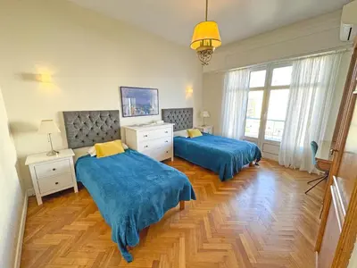 a bedroom with two beds with blue covers in it at Panoramic Sea front Cote d Azur in Nice