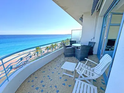 a balcony with chairs and a table and the ocean at Panoramic Sea front Cote d Azur in Nice