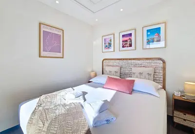 a bedroom with a large white bed with pillows at Nestor&Jeeves - RIVIERA JAURES - Terrace - Close Old Town in Nice