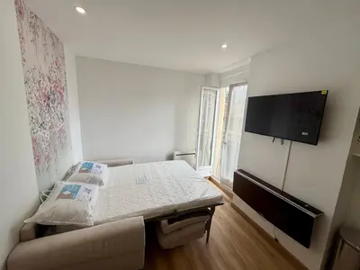 a bedroom with a bed and a flat screen tv at Hello sunshine nice in Nice