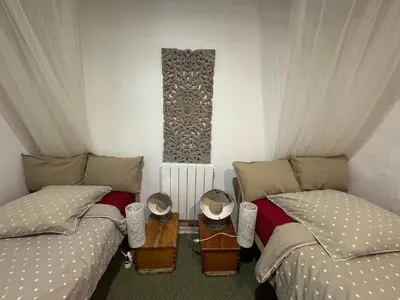 a room with two beds and a table between them at Auberge de la Croix du Pape in Èze