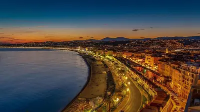 a view of a beach at night with lights at Le Saint François - Au cœur du Vieux Nice in Nice