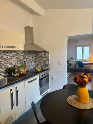 a kitchen with a table and a counter top at Le Saint François - Au cœur du Vieux Nice in Nice