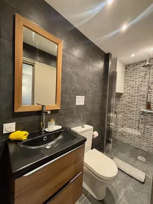 a bathroom with a sink and a toilet and a mirror at Le Saint François - Au cœur du Vieux Nice in Nice