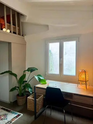 a desk in a room with a window and a plant at Le Saint François - Au cœur du Vieux Nice in Nice