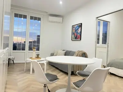 a white living room with a white table and chairs at appartement moderne pour 3 pers Hyper Centre proche Jean Médecin in Nice