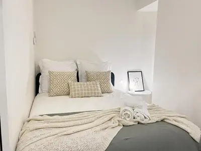 a large bed with pillows and a blanket on it at appartement moderne pour 3 pers Hyper Centre proche Jean Médecin in Nice