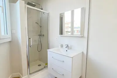 a white bathroom with a shower and a sink at appartement moderne pour 3 pers Hyper Centre proche Jean Médecin in Nice